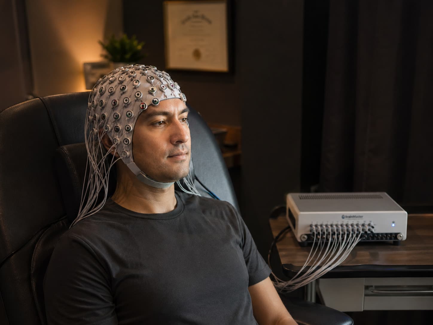 Client wearing EEG cap during a neurofeedback training session